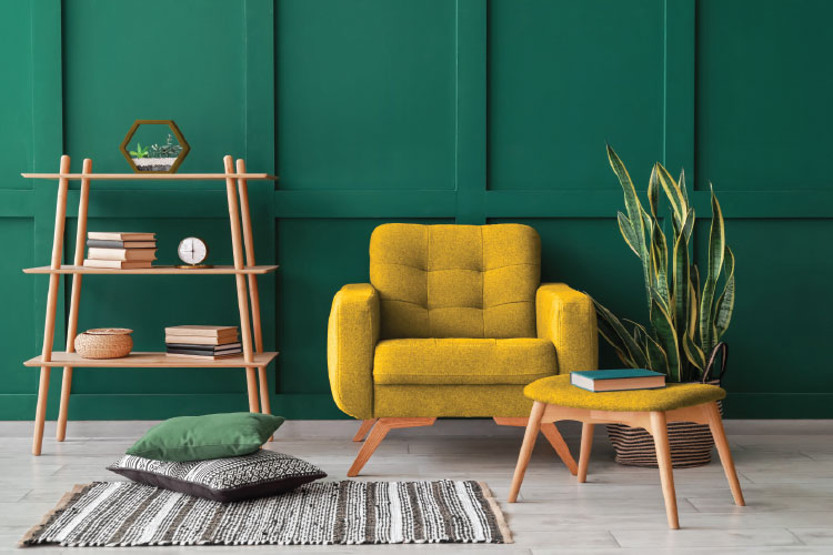 Modern living room interior with green wall paneling, yellow armchair and natural wood furniture