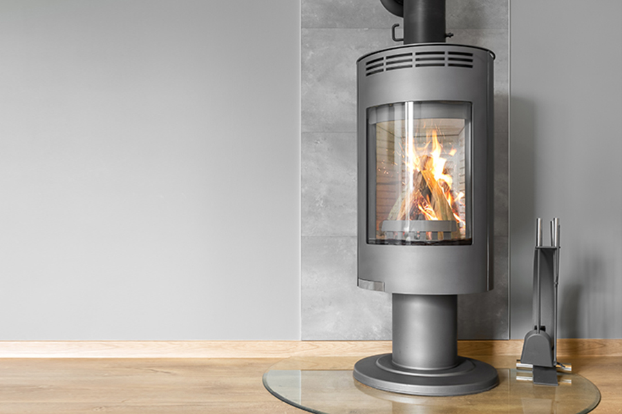 Gray industrial furnace visibly heated in an empty indoor space