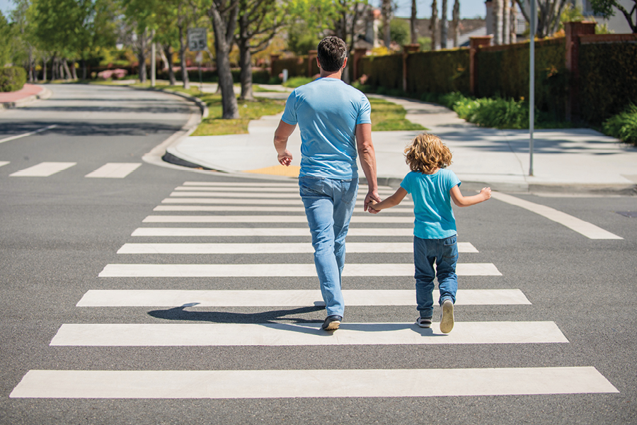 Father and son on the road crossing