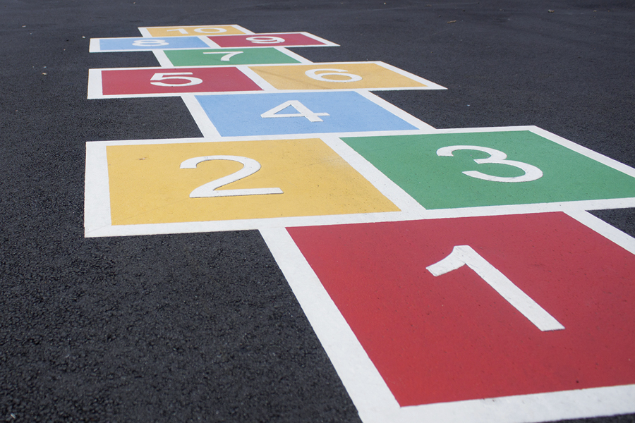 child's game on asphalt with numbers and colours