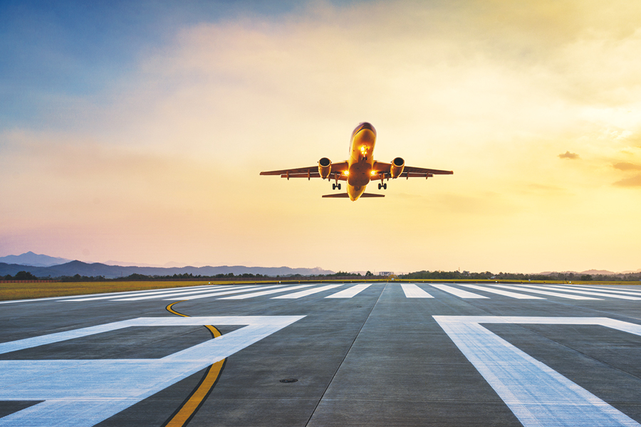 airplane in the air above the airport lane