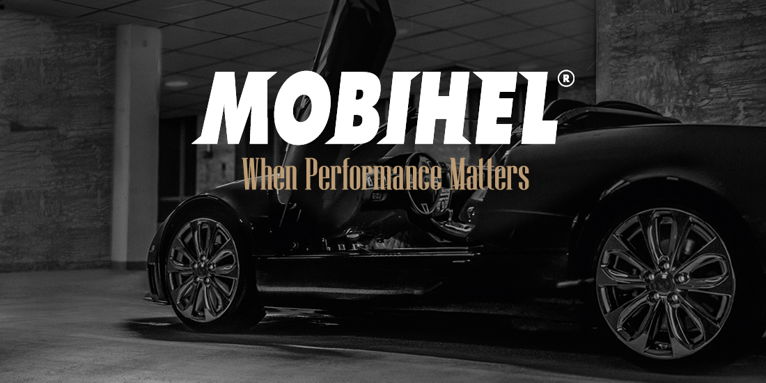 Refinish-Brands-Group-Site-01-Mobihel A banner featuring a sleek black sports car with its door open in a dimly lit indoor space. The text "MOBIHEL" appears in bold white letters, with the slogan "When Performance Matters" in gold below.