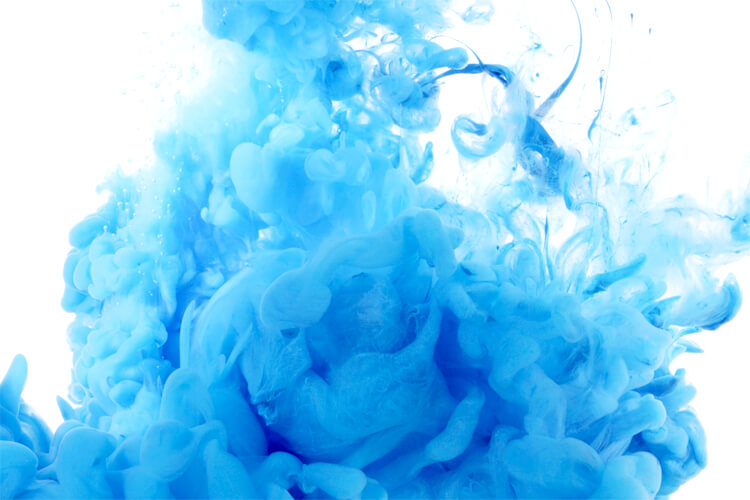 Blue ink swirling in water, creating an abstract fluid pattern for color and coating applications
