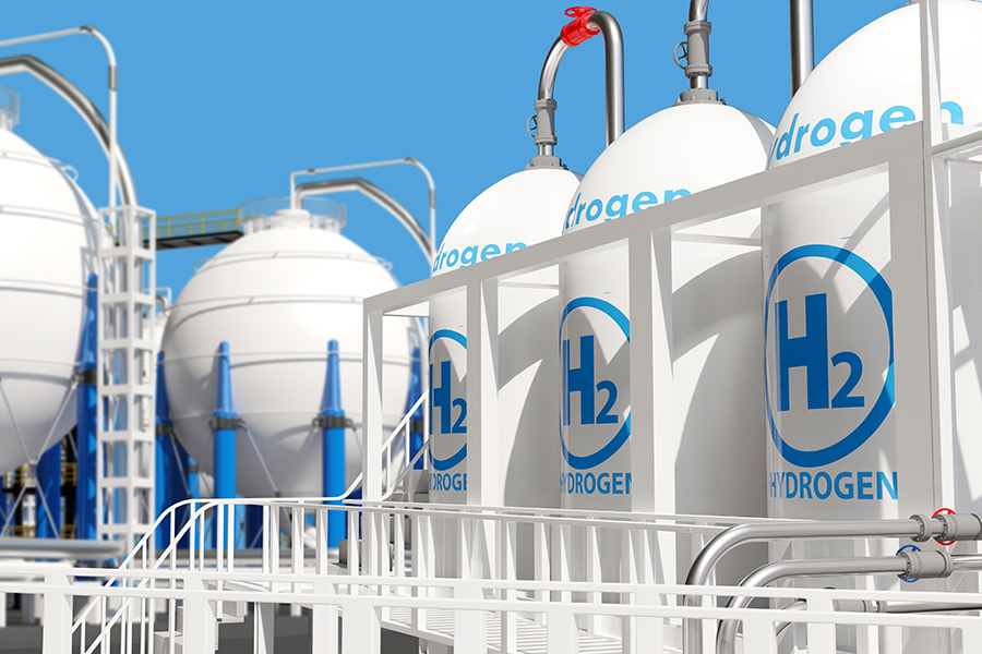 hydrogen_storage_stock_2466035343 ndustrial hydrogen storage tanks with blue and white branding under a clear sky, used for clean energy production and electricity generation from H₂