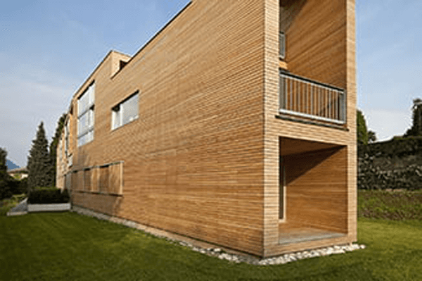 Modern house with wooden façade and balcony – durable wood coatings for exterior architectural surfaces.